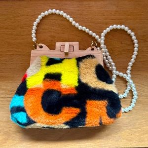 Purse with printed faux fur detail and pearl strap